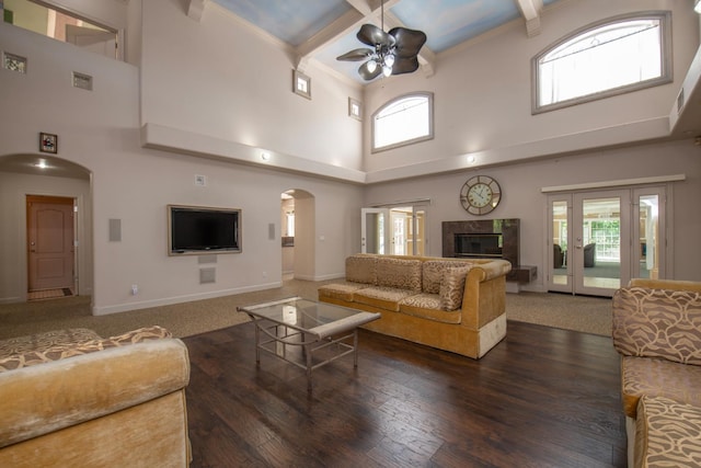 8067 E Belmont Ave, Fresno, CA 93737 - living area featuring ceiling fan, arched walkways, a towering ceiling, baseboards, and wood finished floors
