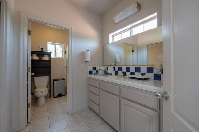 8067 E Belmont Ave, Fresno, CA 93737 - bathroom featuring vanity, tasteful backsplash, tile patterned floors, and toilet