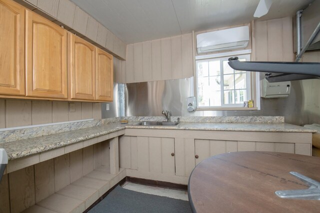 8067 E Belmont Ave, Fresno, CA 93737 - kitchen with a sink, an AC wall unit, and light stone countertops