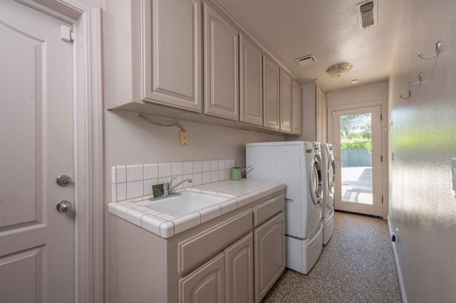 8067 E Belmont Ave, Fresno, CA 93737 - clothes washing area featuring separate washer and dryer, cabinet space, and light colored carpet