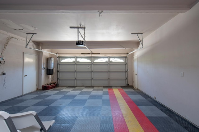 8067 E Belmont Ave, Fresno, CA 93737 - garage with a garage door opener and a central vacuum unit