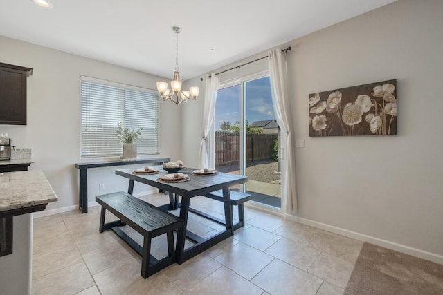 6326 W Sweet Ct, Visalia, CA 93291 - dining area featuring a chandelier, baseboards, and light tile patterned flooring