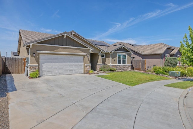 6326 W Sweet Ct, Visalia, CA 93291 - ranch-style house with stone siding, stucco siding, driveway, and an attached garage