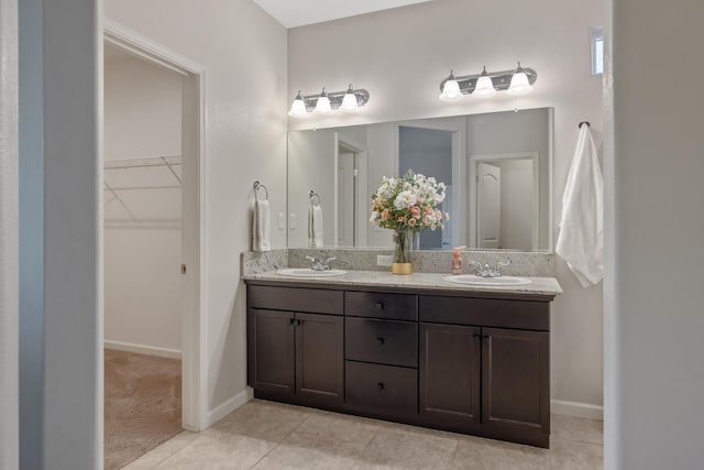 6326 W Sweet Ct, Visalia, CA 93291 - full bath featuring double vanity, a walk in closet, tile patterned floors, and baseboards