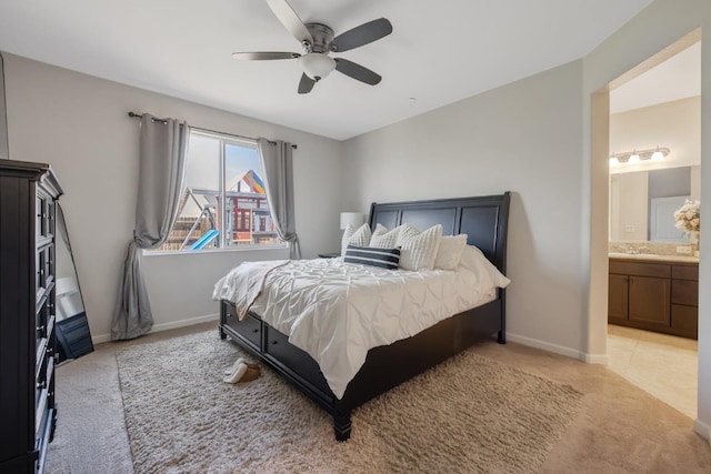 6326 W Sweet Ct, Visalia, CA 93291 - bedroom featuring light carpet, baseboards, ensuite bath, and ceiling fan