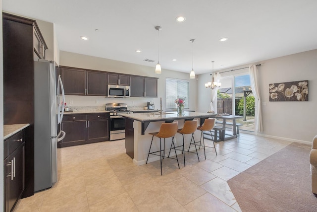 6326 W Sweet Ct, Visalia, CA 93291 - kitchen featuring appliances with stainless steel finishes, a kitchen breakfast bar, a chandelier, recessed lighting, and dark brown cabinetry