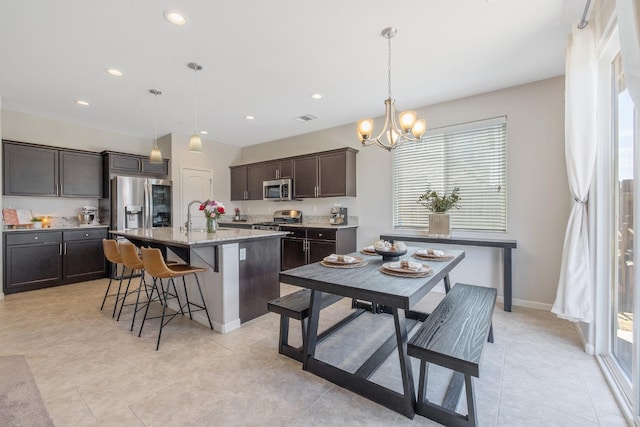 6326 W Sweet Ct, Visalia, CA 93291 - dining room featuring a chandelier, recessed lighting, light tile patterned floors, and baseboards