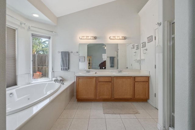 full bathroom featuring a bath, tile patterned floors, and double vanity