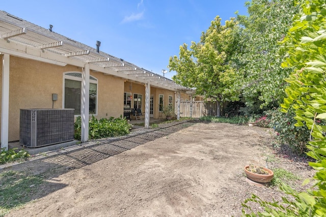 view of patio / terrace with a pergola, cooling unit, and fence