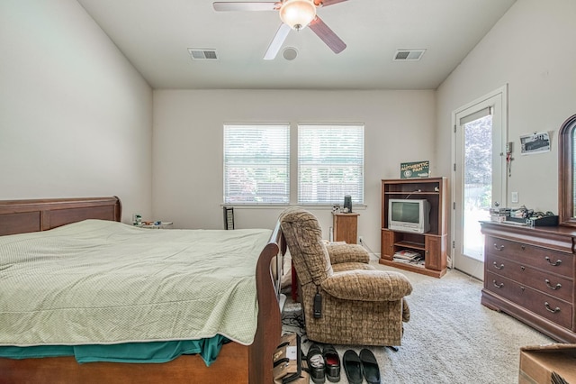 bedroom featuring access to outside, light colored carpet, and a ceiling fan