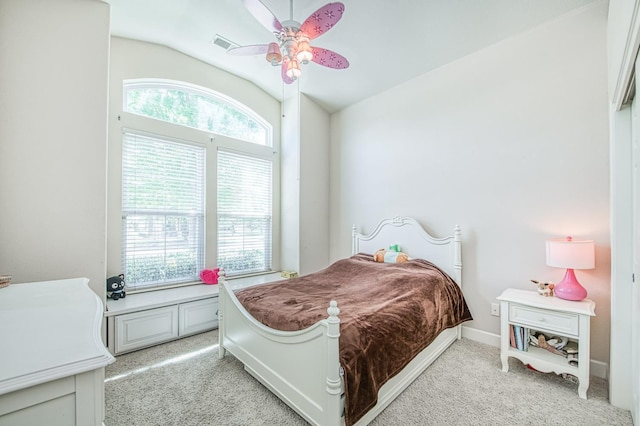 bedroom featuring light colored carpet, vaulted ceiling, and ceiling fan