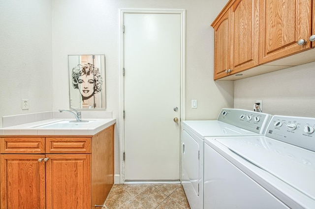 washroom with washing machine and dryer, cabinet space, and tile patterned floors