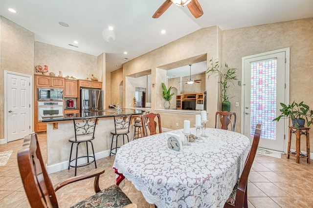 dining room with ceiling fan, light tile patterned flooring, recessed lighting, and lofted ceiling