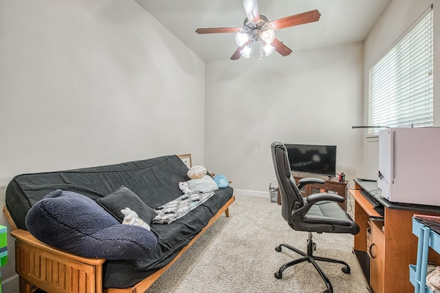 carpeted home office featuring a ceiling fan and baseboards