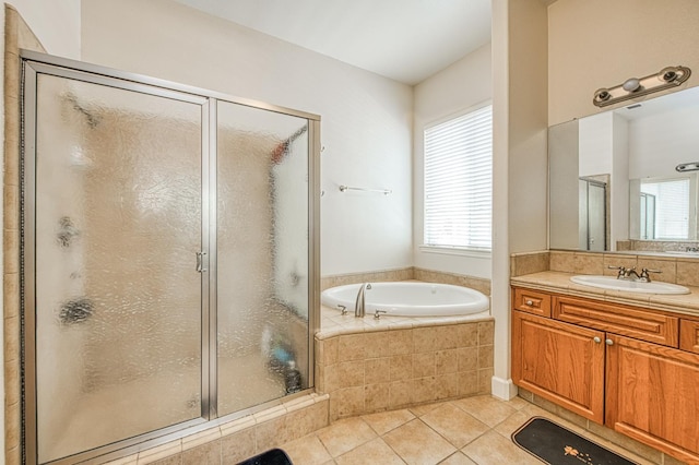 full bath with tile patterned floors, a garden tub, a shower stall, and vanity