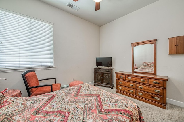 carpeted bedroom featuring baseboards and a ceiling fan