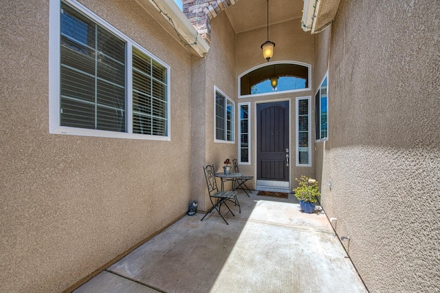 doorway to property with stucco siding
