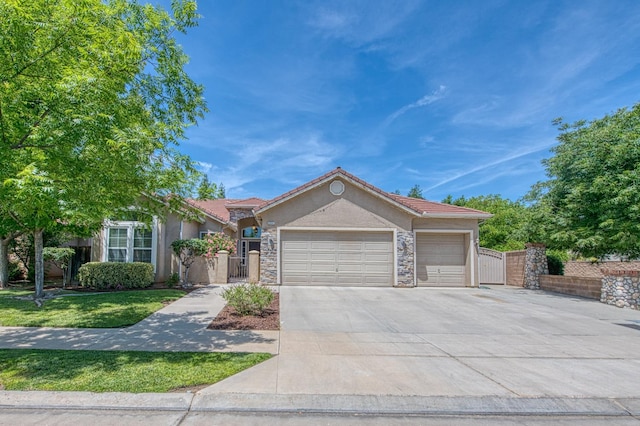 ranch-style home with a gate, stucco siding, a garage, concrete driveway, and a tiled roof