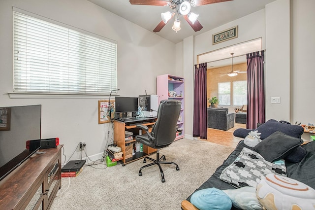 carpeted home office with a ceiling fan and baseboards