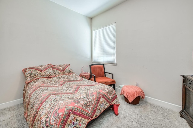 carpeted bedroom featuring baseboards
