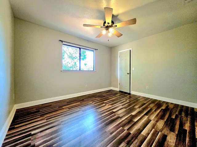 41549 Long Hollow Dr, Coarsegold, CA 93614 - empty room with dark wood-style flooring, baseboards, and a ceiling fan