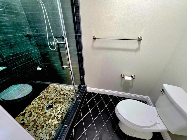 41549 Long Hollow Dr, Coarsegold, CA 93614 - full bathroom with tile patterned floors, toilet, a stall shower, and baseboards