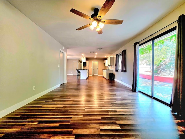 41549 Long Hollow Dr, Coarsegold, CA 93614 - unfurnished living room featuring dark wood-type flooring, ceiling fan, baseboards, and recessed lighting