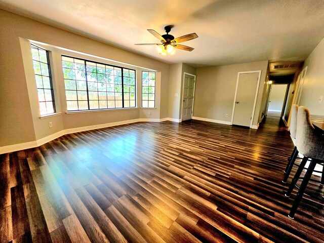 41549 Long Hollow Dr, Coarsegold, CA 93614 - unfurnished living room with dark wood-style flooring, ceiling fan, and baseboards