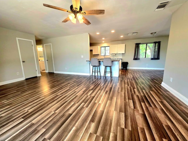 41549 Long Hollow Dr, Coarsegold, CA 93614 - unfurnished living room featuring baseboards, dark wood-type flooring, recessed lighting, and ceiling fan