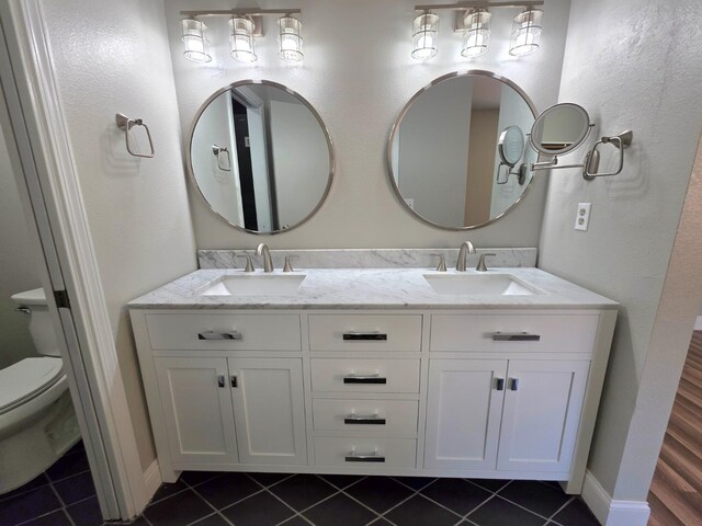 41549 Long Hollow Dr, Coarsegold, CA 93614 - full bath featuring toilet, double vanity, tile patterned floors, and baseboards