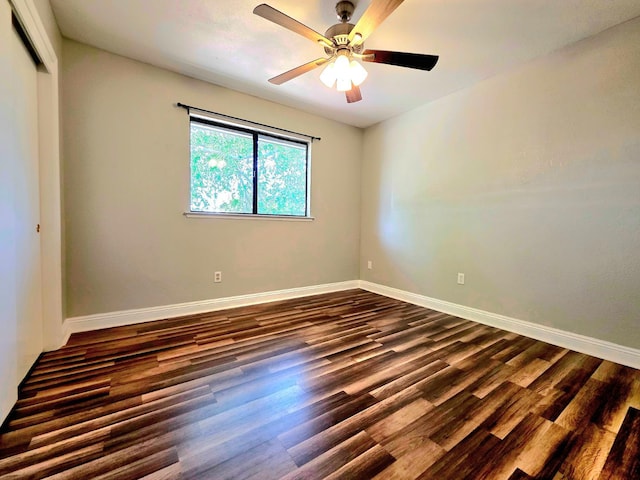 41549 Long Hollow Dr, Coarsegold, CA 93614 - unfurnished room with dark wood finished floors, a ceiling fan, and baseboards