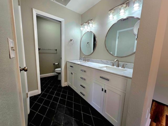 41549 Long Hollow Dr, Coarsegold, CA 93614 - bathroom with double vanity, tile patterned floors, toilet, and baseboards