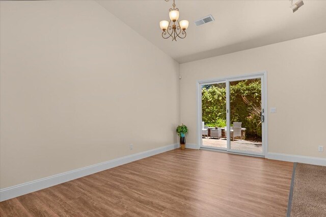 6458 N Warren Ave, Fresno, CA 93711 - unfurnished room featuring a chandelier, baseboards, lofted ceiling, and wood finished floors