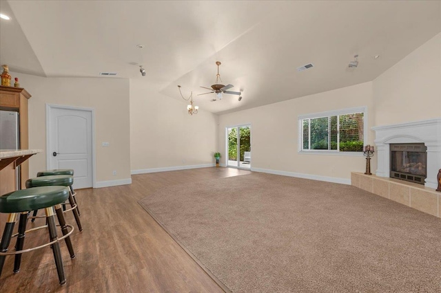 6458 N Warren Ave, Fresno, CA 93711 - unfurnished living room with a fireplace, light wood-style flooring, baseboards, a chandelier, and high vaulted ceiling