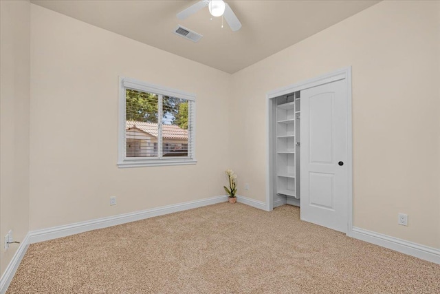 unfurnished bedroom with light carpet, baseboards, a closet, and a ceiling fan