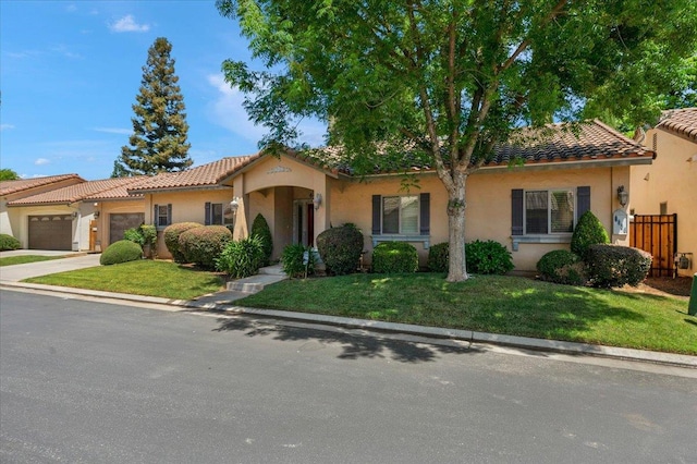 6458 N Warren Ave, Fresno, CA 93711 - mediterranean / spanish home with a garage, concrete driveway, a tiled roof, stucco siding, and a front yard