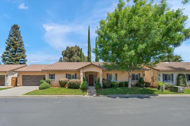 6458 N Warren Ave, Fresno, CA 93711 - mediterranean / spanish-style home with stucco siding, a tiled roof, a front yard, and driveway