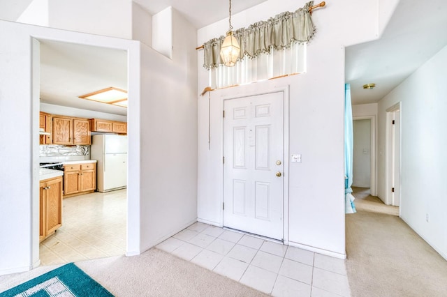 2670 N Katy Ave, Fresno, CA 93722 - entryway featuring a chandelier, light carpet, and light tile patterned flooring