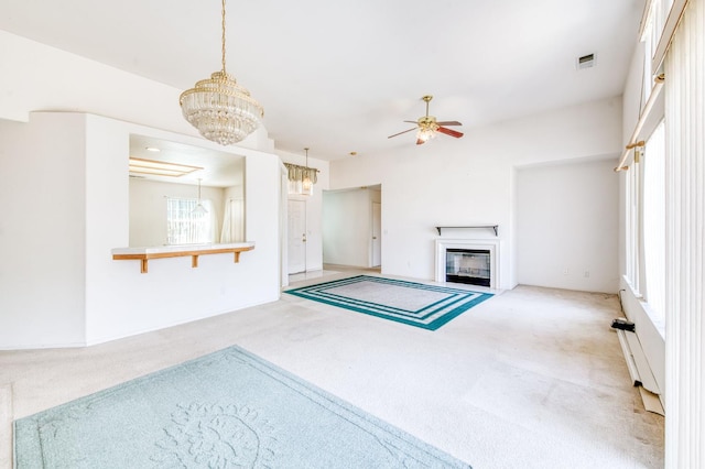 2670 N Katy Ave, Fresno, CA 93722 - unfurnished living room with carpet flooring, ceiling fan, a chandelier, and a fireplace with flush hearth