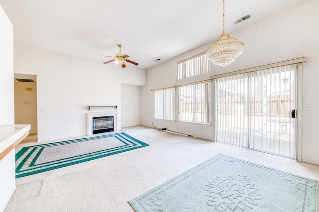 2670 N Katy Ave, Fresno, CA 93722 - unfurnished living room featuring carpet, a fireplace with flush hearth, a ceiling fan, and a chandelier