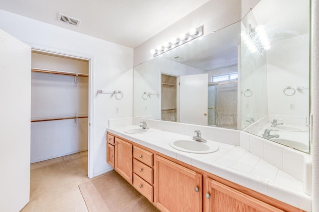 2670 N Katy Ave, Fresno, CA 93722 - full bath featuring double vanity, a walk in closet, and a shower with door
