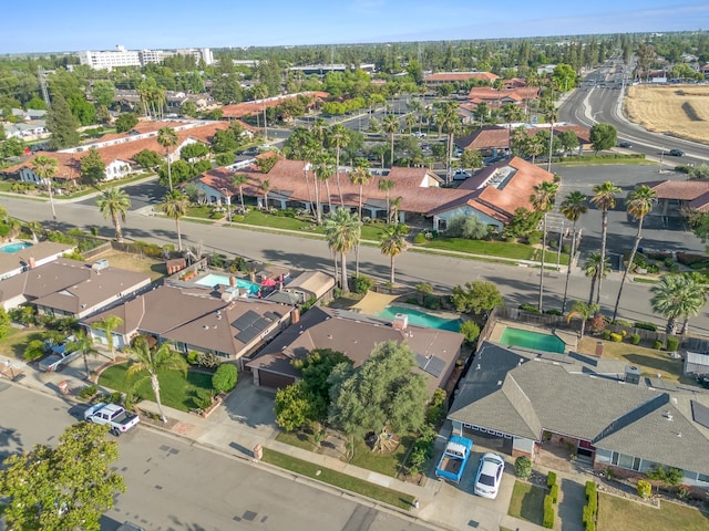 aerial overview of property's location with nearby suburban area and a pool area