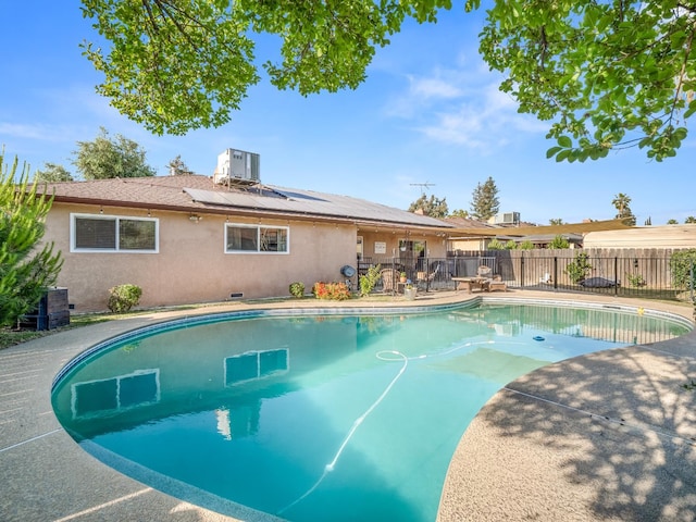 view of swimming pool featuring fence and central AC