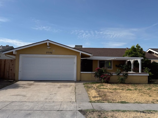 single story home featuring concrete driveway, a garage, fence, and stucco siding