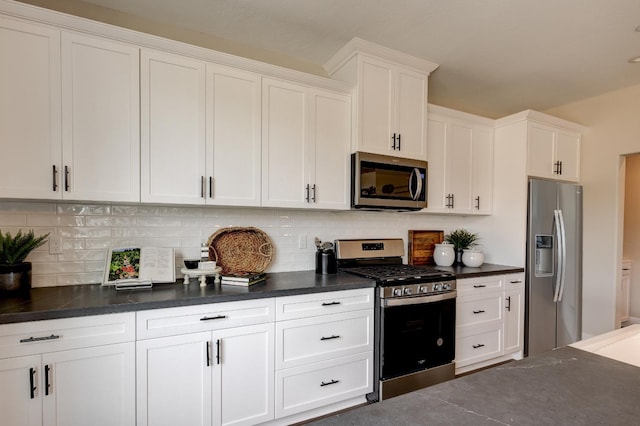 1179 Maclure Ave W, Madera, CA 93636 - kitchen featuring stainless steel appliances, dark countertops, white cabinets, and tasteful backsplash