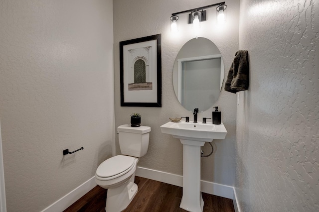 1179 Maclure Ave W, Madera, CA 93636 - half bath featuring wood finished floors, toilet, and baseboards
