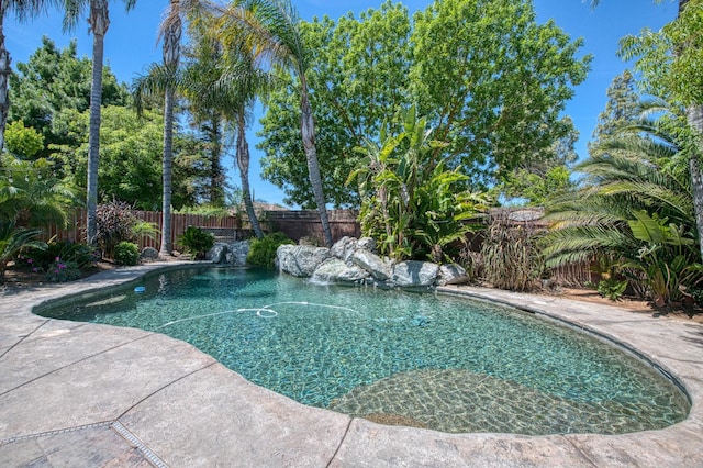 view of swimming pool with a fenced backyard