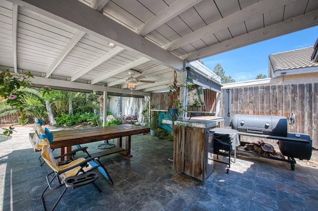 view of patio / terrace featuring ceiling fan and fence