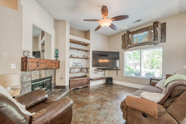 living room featuring finished concrete flooring, ceiling fan, baseboards, and a fireplace