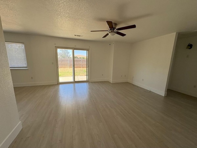 1073 Hickory St, Lindsay, CA 93247 - spare room featuring a ceiling fan, wood finished floors, baseboards, and a textured ceiling